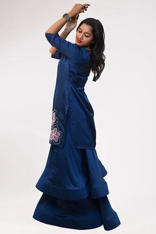 The Almond Blossom Lehenga from the side, a single blossom on the tunic and the navy skirt falling full to the floor
