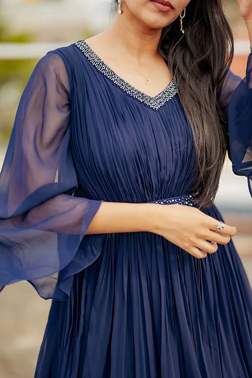 The Pleated Gown's bodice, showing the silver beaded V neckline, the gathered pleating below it and the wide sheer sleeve
